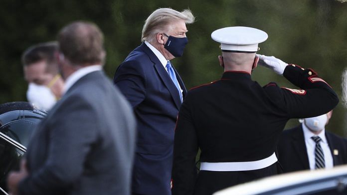 US President Donald Trump exits Marine One while arriving at Walter Reed National Military Medical Center in Bethesda, Maryland on 2 October | Photo via Bloomberg