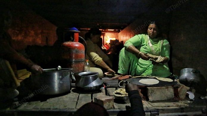Women sitting in the trucks make chapattis | Photo: Manisha Mondal | ThePrint