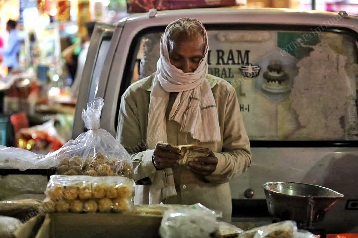 A shopkeeper counts his Diwali earning | Photo: Manisha Mondal | ThePrint