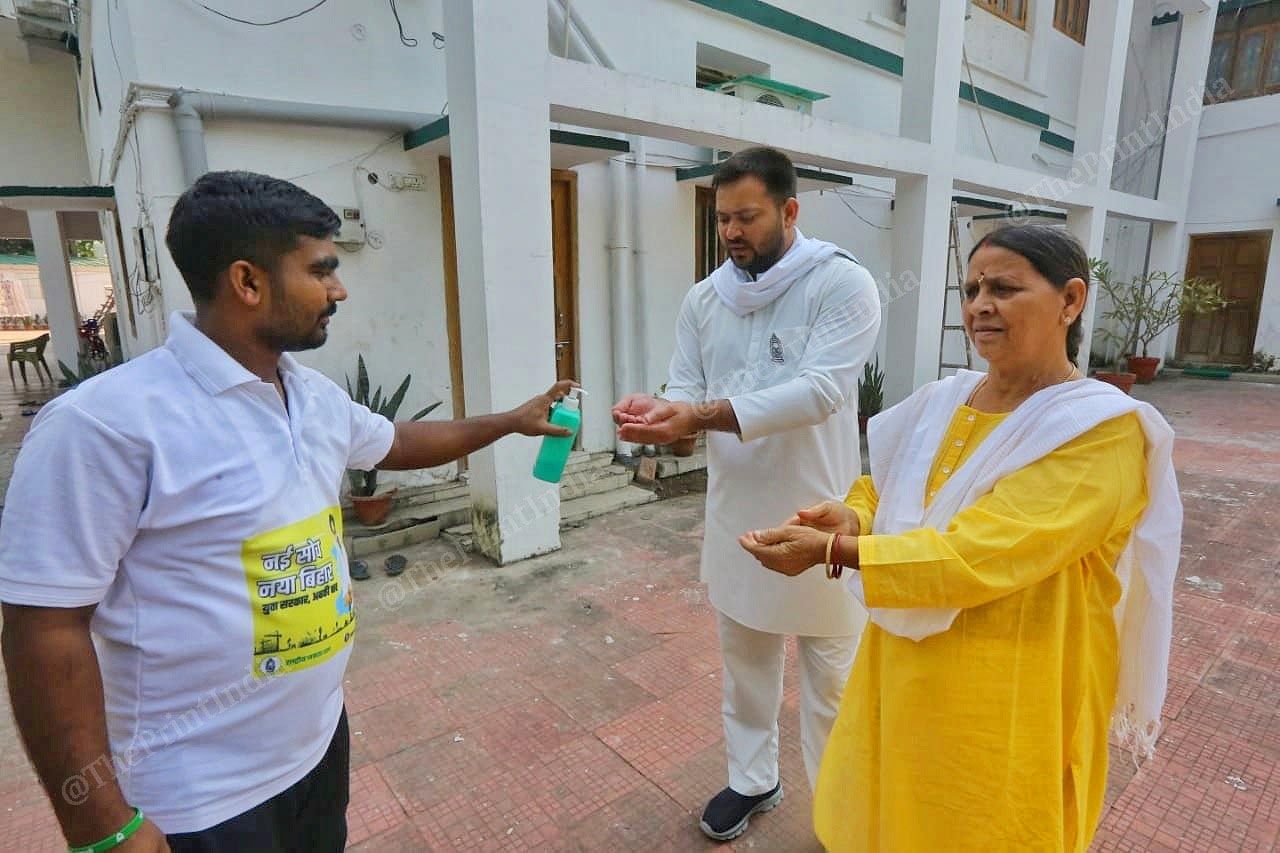 Former CM of Bihar Rabri Devi and his son Tejashwi sanitizing hands at their residence | Praveen Jain | ThePrint