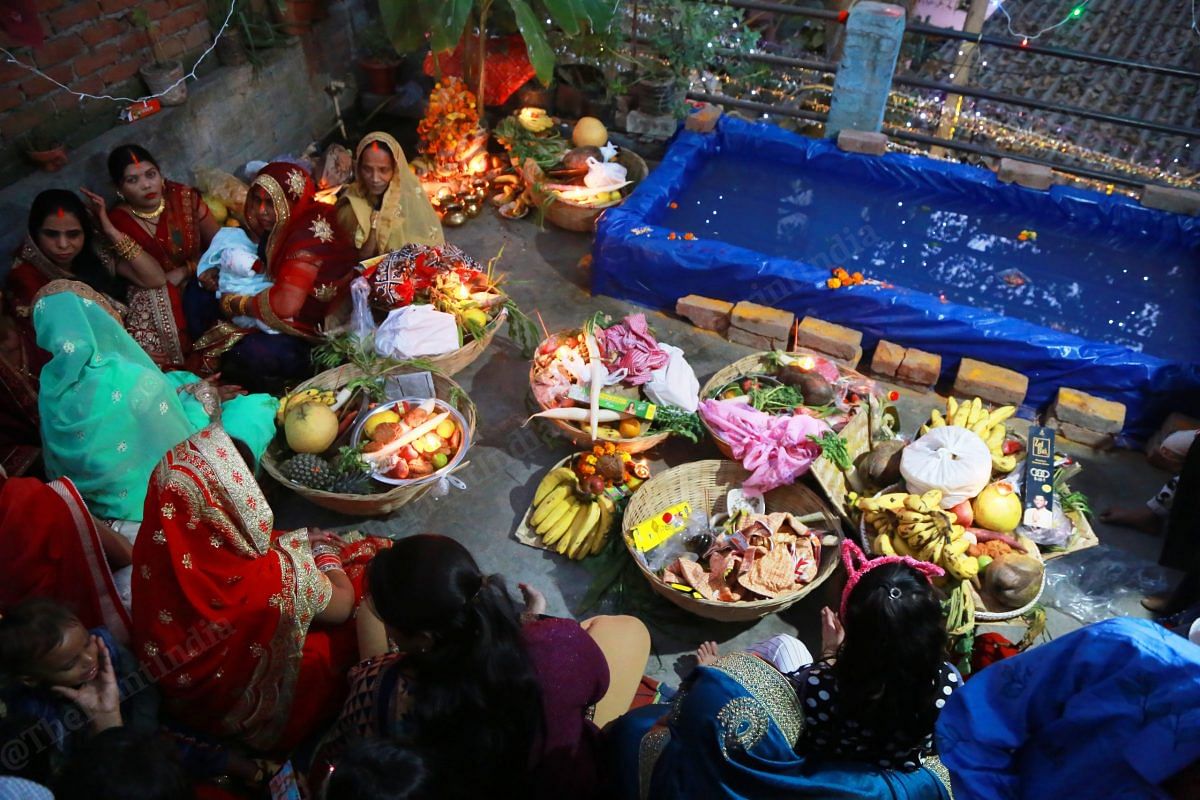 Women sit on a terrace after finishing puja | Photo: Manisha Mondal | ThePrint