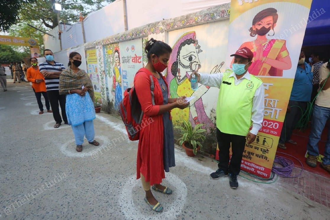 volunteer spray sanatize to people before caste vote at Raj Bhavan Complex | Praveen Jain | ThePrint