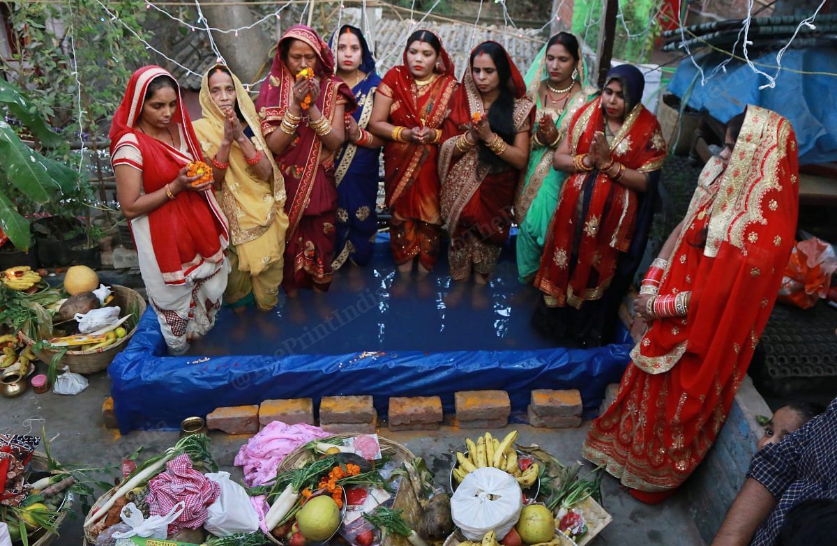 Women perform rituals on the terrace of a house in ITO | Photo: Manisha Mondal | ThePrint