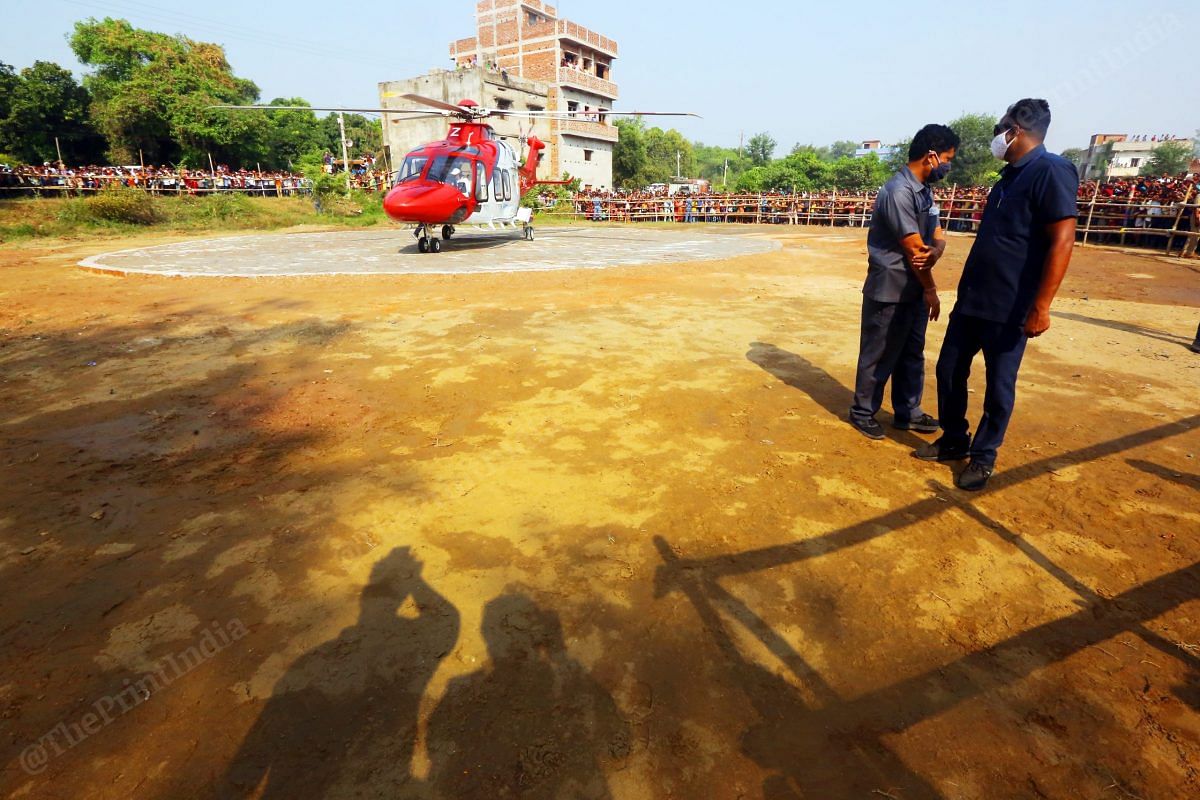 CM Nitish Kumar's helicopter lands in Nalanda, while security personnel guard near the bouandaries | Photo: Praveen Jain | ThePrint