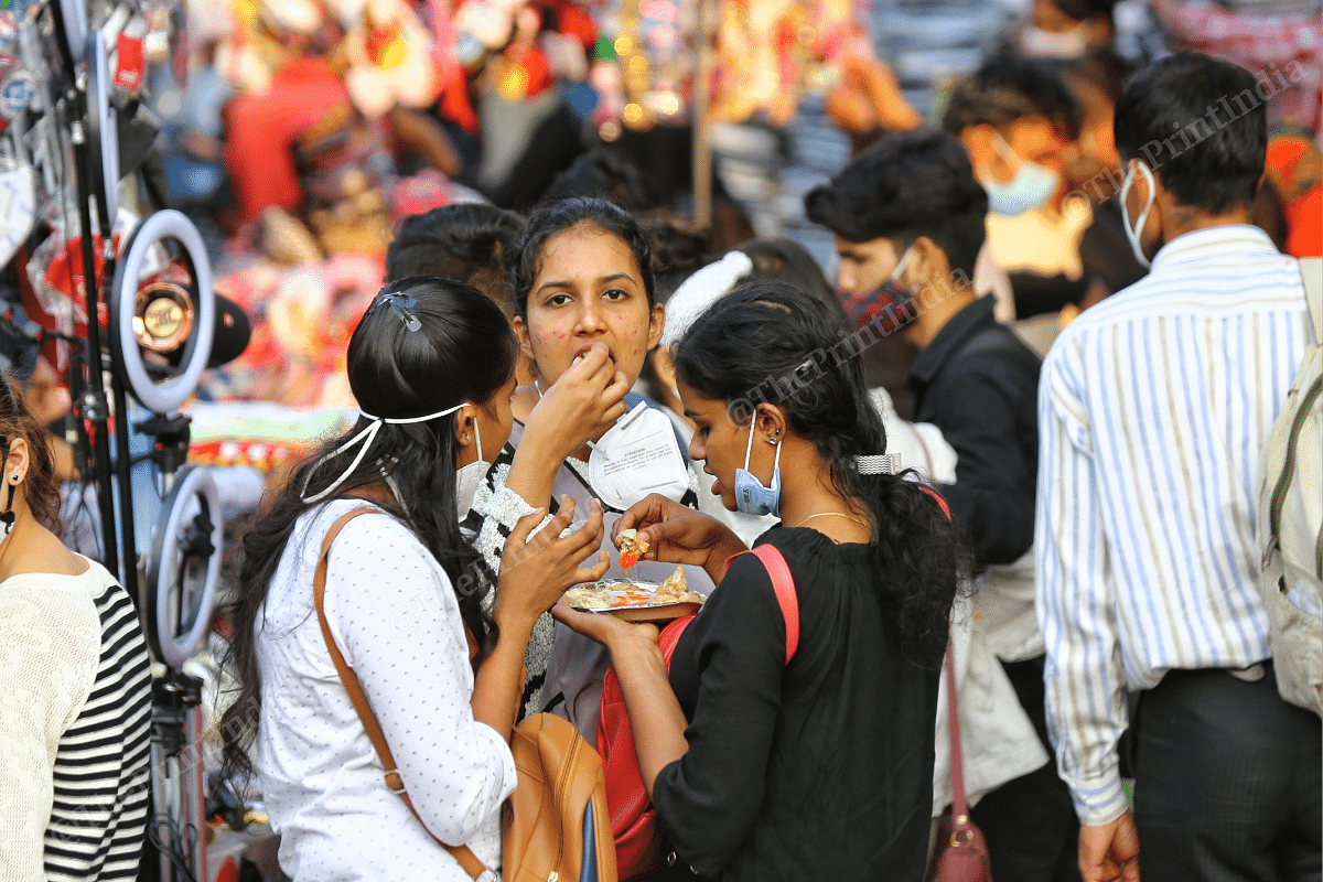 People enjoy snacks at a crowded market in Sarojini market | Photo: Suraj Singh Bisht | ThePrint