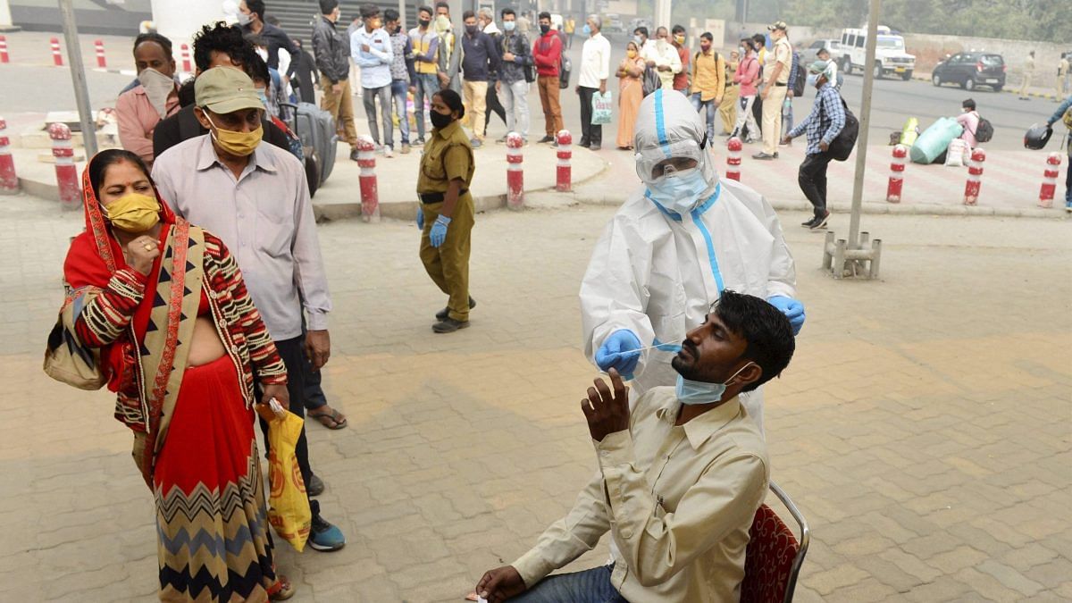 A health worker conducts COVID-19 RAT test at Anand Vihar Bus Terminal, New Delhi | PTI