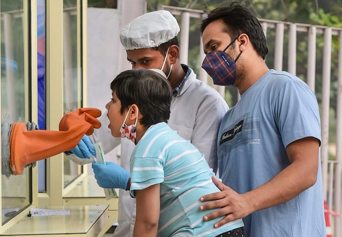A health worker collects swab samples for Covid-19 test, in New Delhi 9 November 2020. | PTI/Kamal Kishore