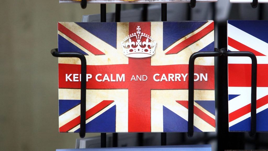 A postcard reading "Keep Calm and Carry On" sits in a rack outside a newsagent in London in 2016 | Photographer: Chris Ratcliffe | Bloomberg