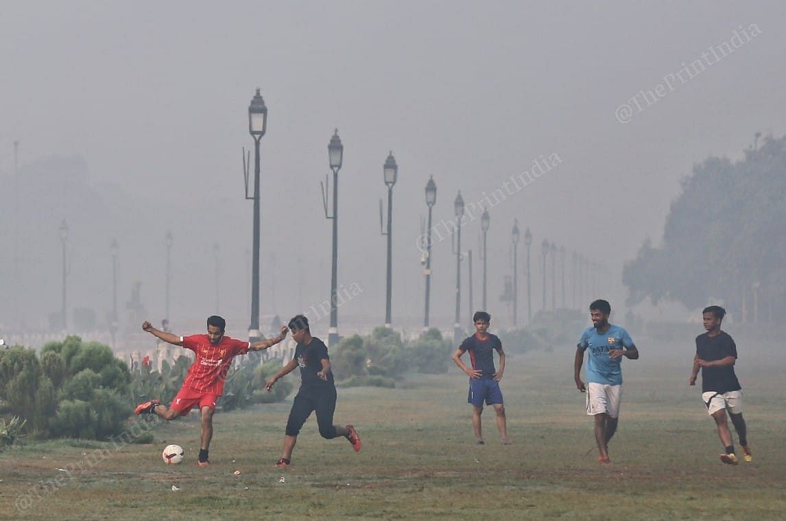 A few men seen playing football near the India Gate | Photo: Suraj Singh Bisht | ThePrint