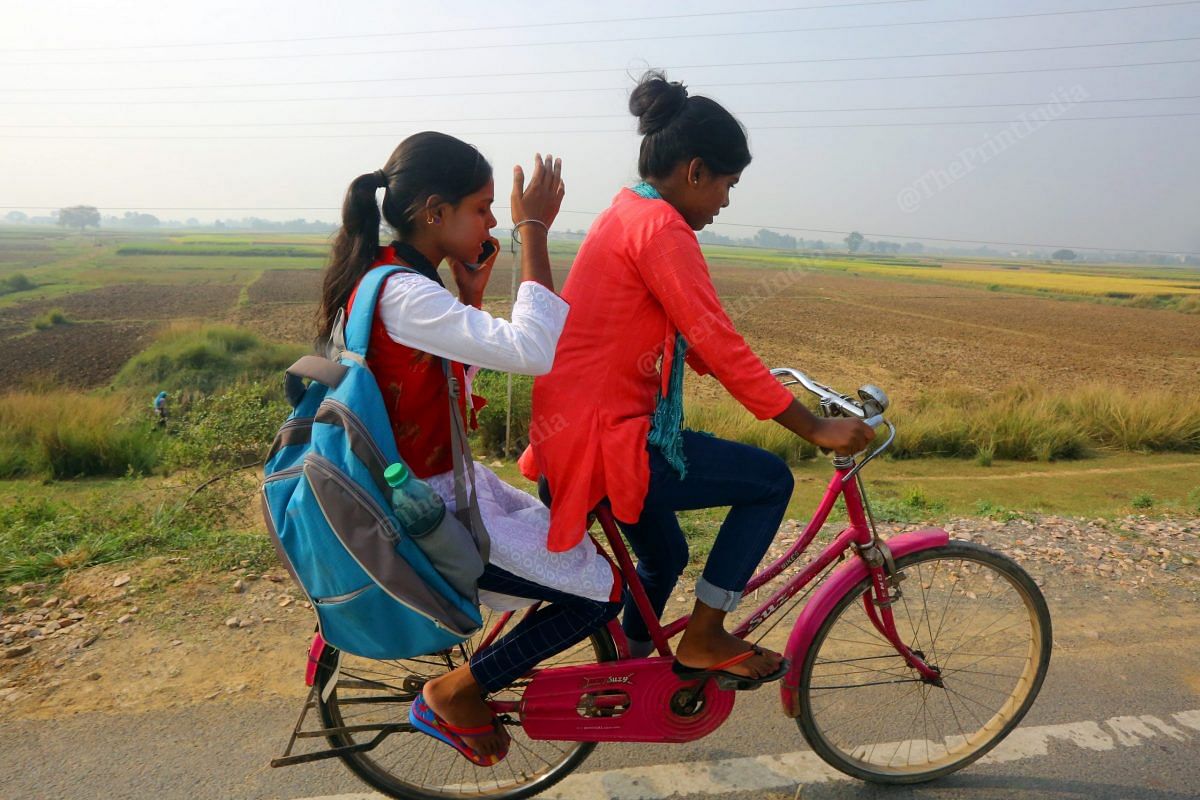 Two girls enjoying bicycle ride in their village in Punadih on the voting day. Nitish Kumar's government had given cycles to the girls who had passed class 9 so that they could easily travel to school | Photo: Praveen Jain | ThePrint