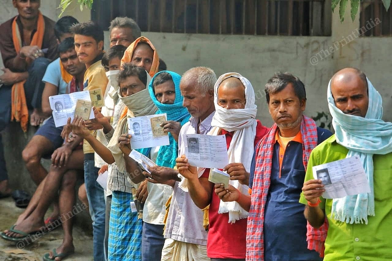 People stand in queue with their voter slip in Sharbadha Fatuha village | Praveen Jain | ThePrint