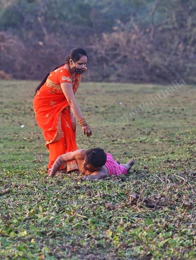 A wife helps husband in doing the ritual | Photo: Praveen Jain | ThePrint