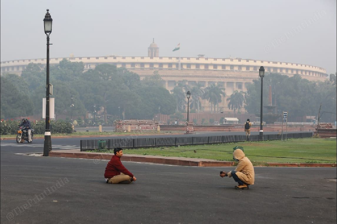 Two men clicking photos near the Parliament Sunday | Photo: Suraj Singh Bisht | ThePrint
