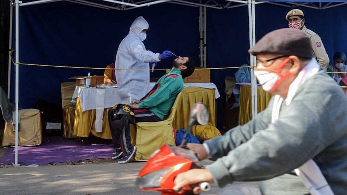 A health worker collects swab sample from people for RT-PCR Covid test at Najafgarh in New Delhi on 20 November 2020 (representational image) | ANI
