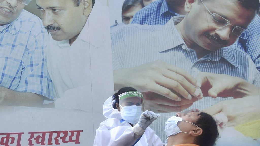 A health worker conducts Covid test outside a mohalla clinic in Delhi, 20 Nov 2020 | PTI