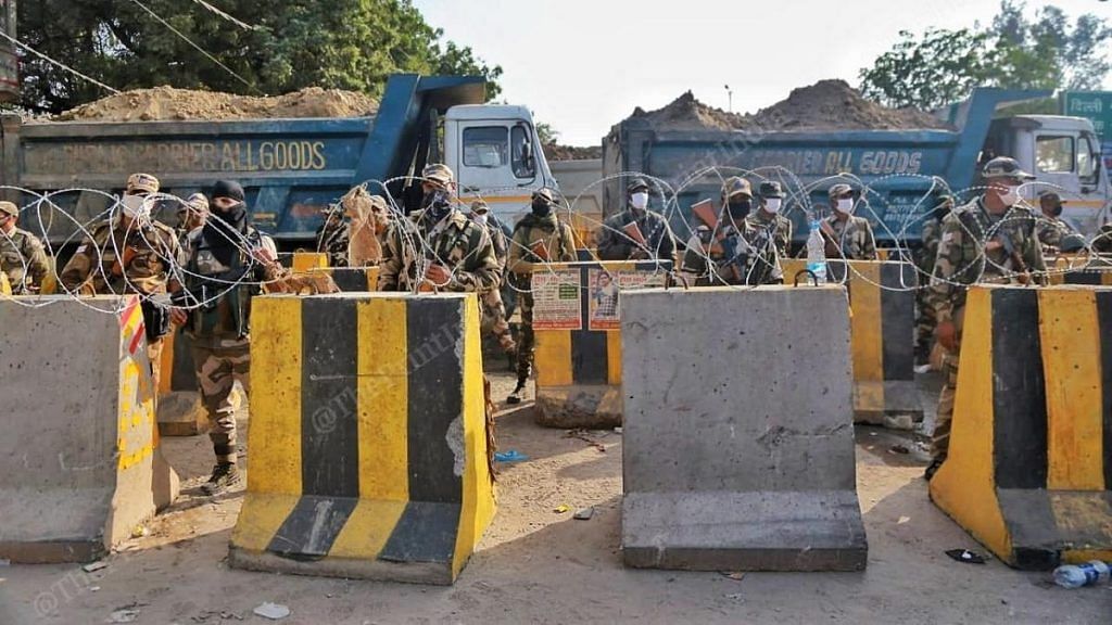 BSF and CISF personnel along with barricades and barbed wire deployed at the Singhu border in north Delhi to prevent farmers from marching into the national capital | Photo: Manisha Mondal