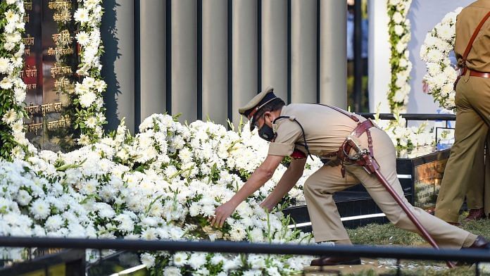 A policeman pays tribute to martyrs at Police Memorial during the 12th anniversary of the 26/11 Mumbai terror attacks, in Mumbai | PTI Photo/Kunal Patil