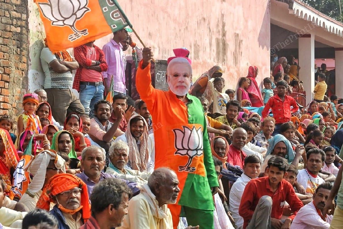 A BJP supporter wearing a mask of Narendra Modi during the election rally in Darbanga | Praveen Jain | ThePrint