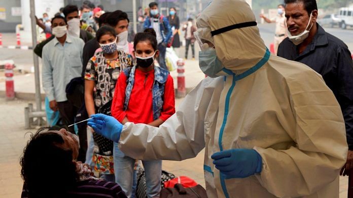 A health worker conducts Covid-19 RAT test at Anand Vihar Bus Terminal, as coronavirus cases surge across the national capital, in New Delhi Wednesday, on 4 November | PTI