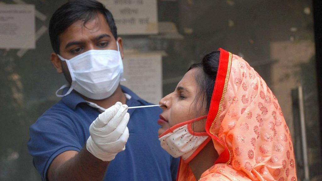 A health worker conducts COVID-19 testing at a district hospital, in Noida, Tuesday, Nov. 17, 2020. | PTI