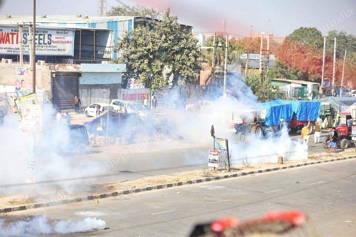Police use tear gas to disperse farmers protesting against Centre's farm laws, at Singhu border Friday | Photo: Manisha Mondal | ThePrint