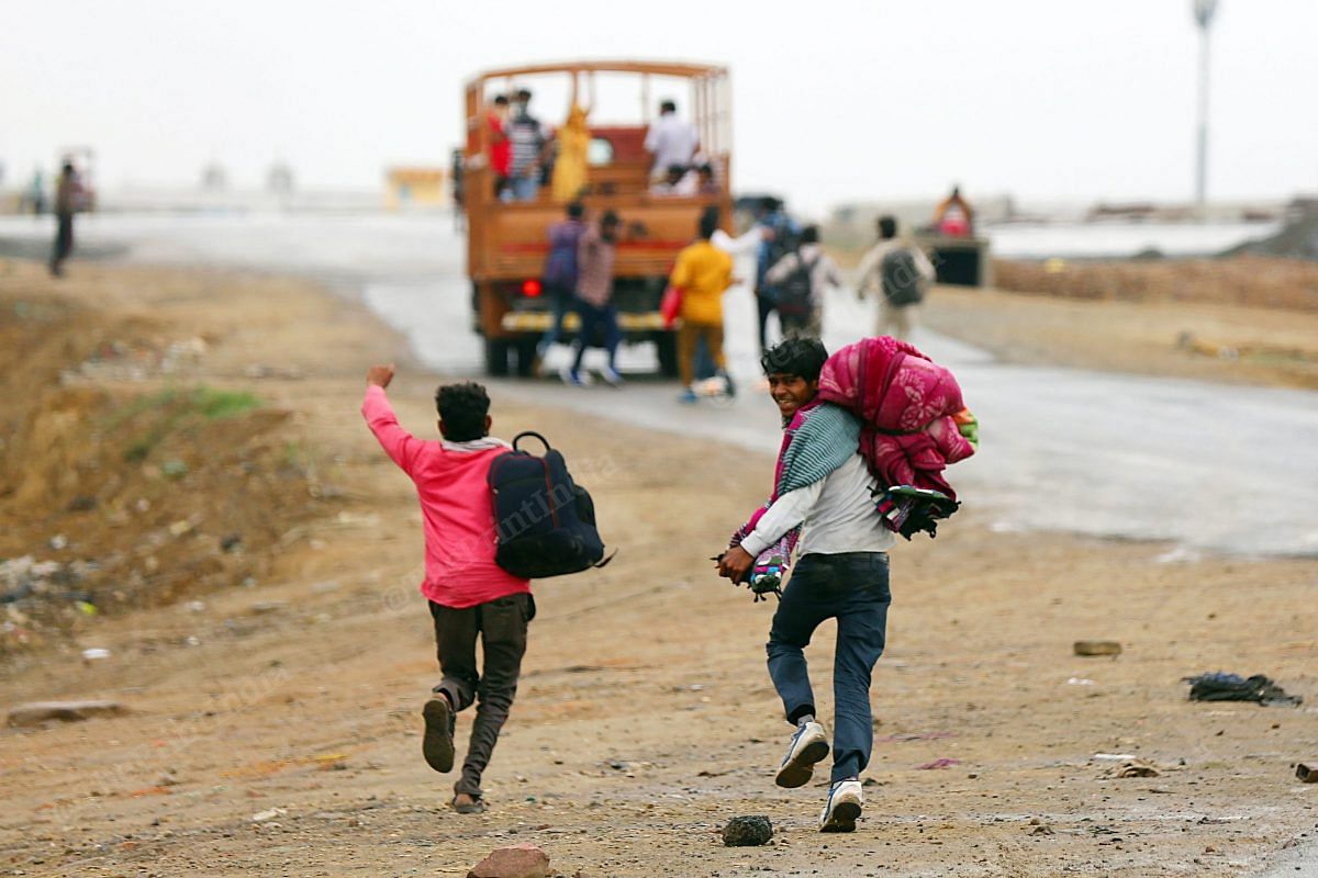 Two kids near Delhi-Uttar Pradesh border running to board a vehicle to their home | Photo: Suraj Singh Bisht | ThePrint