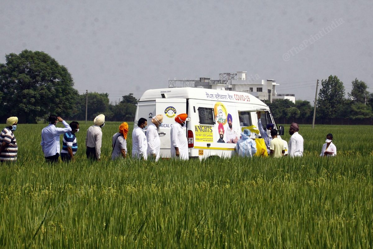 Few locals gathered to get themselves tested for coronavirus as they saw a mobile testing van passing by in Sahnewal village near Ludhiana | Praveen Jain | ThePrint.