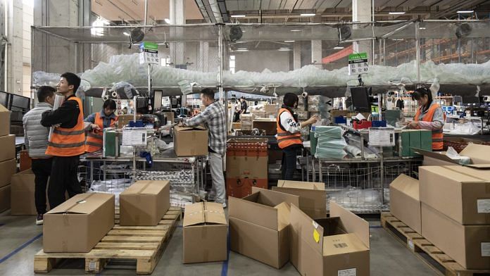 Employees pack orders at Alibaba's logistics arm Cainiao in Wuxi ahead of the Singles' Day shopping extravaganza | Bloomberg