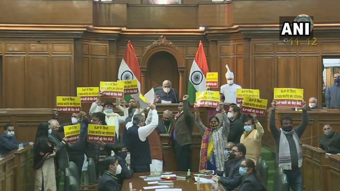 Aam Aadmi Party MLAs display placards alleging BJP of a Rs 2,500 crores scam during Delhi Assembly session on 18 December 2020 | ANI