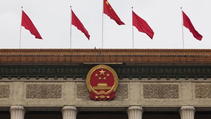 The Chinese national emblem and flags are displayed above the Great Hall of the People in Beijing, China | Representational image | Photo: Giulia Marchi | Bloomberg