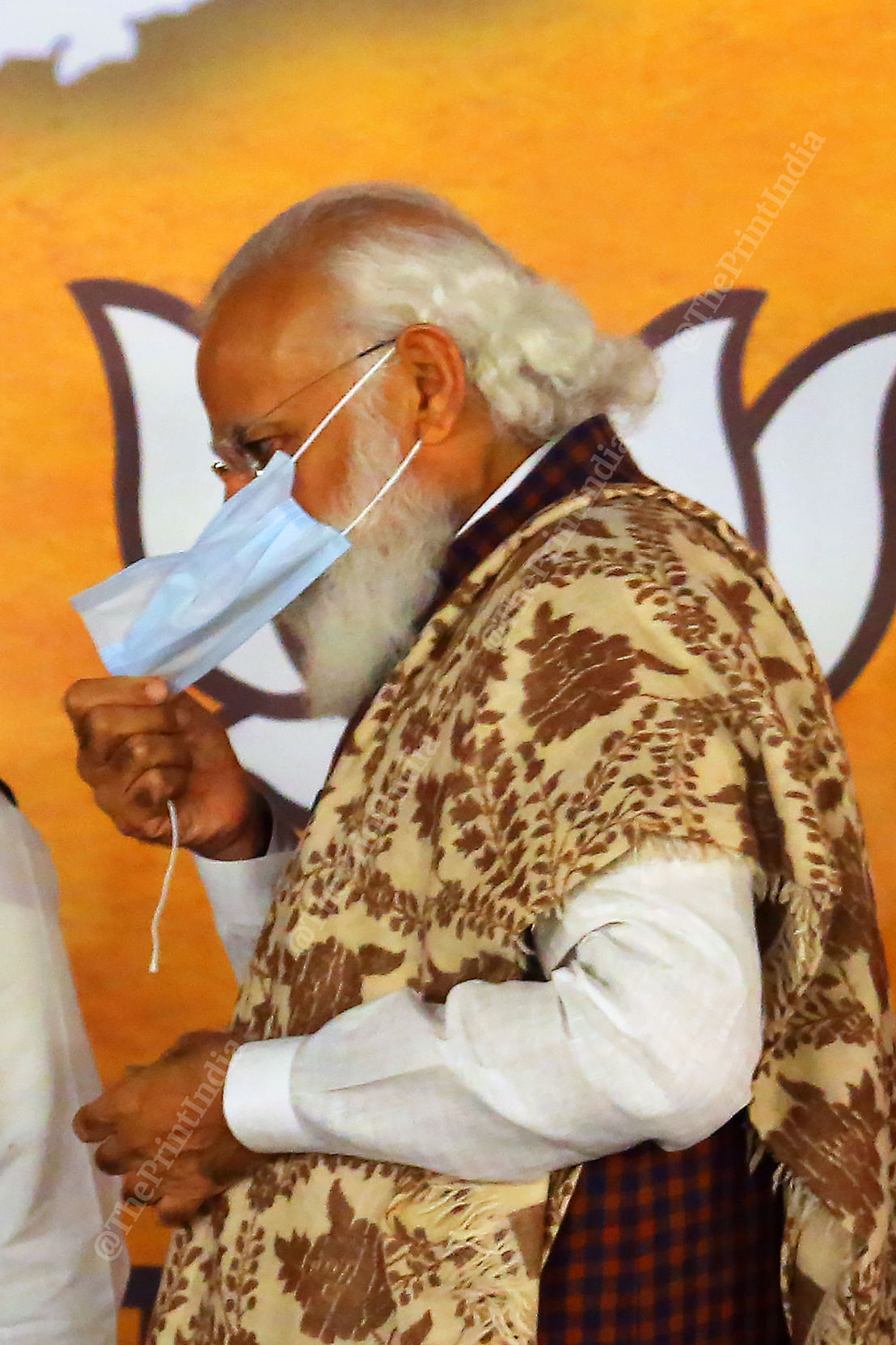 PM Modi trying to cover his face after the elastic string of his face mask snapped Photo: Praveen Jain | ThePrint