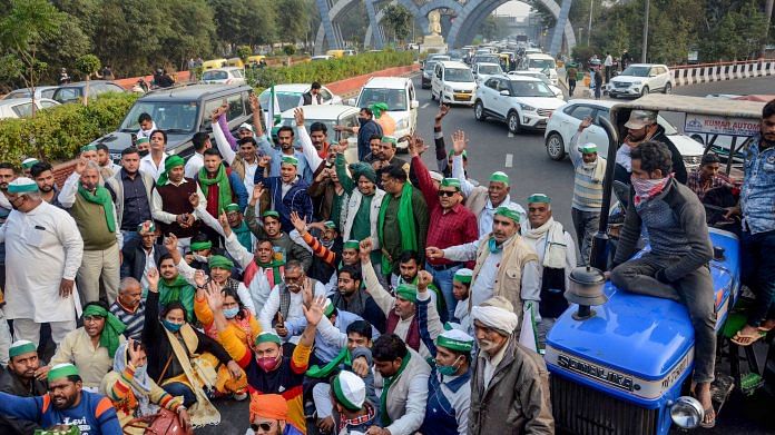 Farmers stage a protest at Delhi-Noida border against new farm laws, in Noida on 1 December | PTI Photo