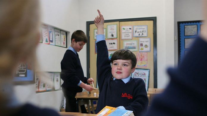 A student raises his hand during class in a school in the UK (representative image) | Photographer: Suzanne Plunkett | Bloomberg