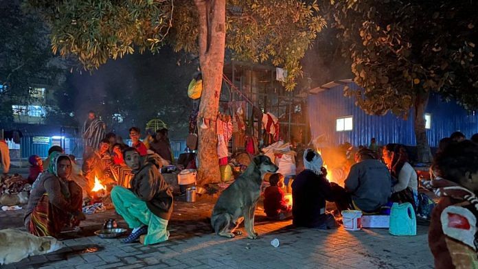 People at the Sarai Kale Khan night shelter complex light fires to brave the biting cold | Photo: Revathi Krishnan | ThePrint