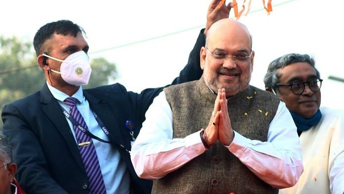 Union Home Minister Amit Shah greets his supporters during a roadshow in Bolpur on 20 December. | Photo: ANI