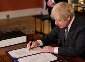 British Prime Minister Boris Johnson signs the Brexit deal on 30 December, 2020 | @BorisJohnson | Twitter