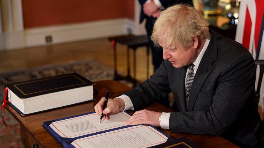 British Prime Minister Boris Johnson signs the Brexit deal on 30 December, 2020 | @BorisJohnson | Twitter