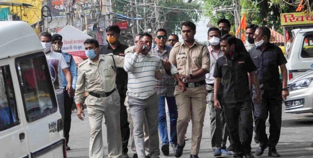 File photo | Gangster Vikas Dubey being apprehended by police personnel in Ujjain on 9 July | PTI Photo
