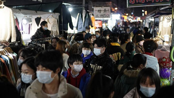 Shoppers at a night market in Wuhan on 10 December