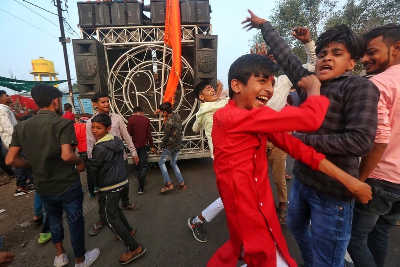 Children dancing in front of the vehicle carrying saffron flags | Photo: Praveen Jain | ThePrint