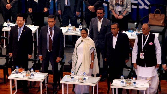 File image of West Bengal CM Mamata Banerjee (centre) and Finance Minister Amit Mitra (right) with global industrialists including Mukesh Ambani at the Bengal Global Business Summit in February 2019 | Photo: ANI