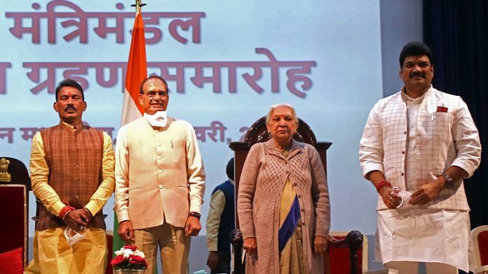 Newly-inducted ministers Tulsiram Silawat (left) and Govind Rajput (right) with Madhya Pradesh CM Shivraj Singh Chouhan and Governor Anandiben Patel Sunday | Photo: ANI