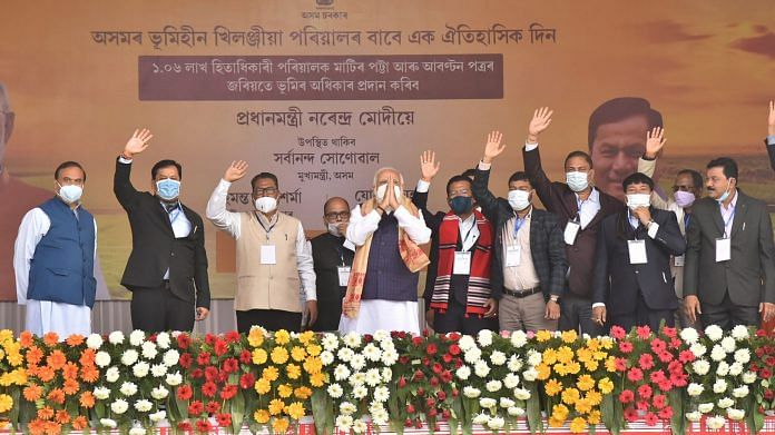 Prime Minister Narendra Modi along with Assam CM Sarbananda Sonowal and others before distributing 'Land Patta' to people during a public meeting, at Jerenga Pathar in Sivasagar District of Assam, Saturday, Jan. 23, 2021. | PTI