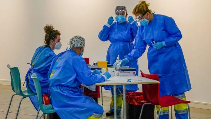 Healthcare workers prepare to perform Covid rapid antigen tests in Madrid, Spain | Bloomberg