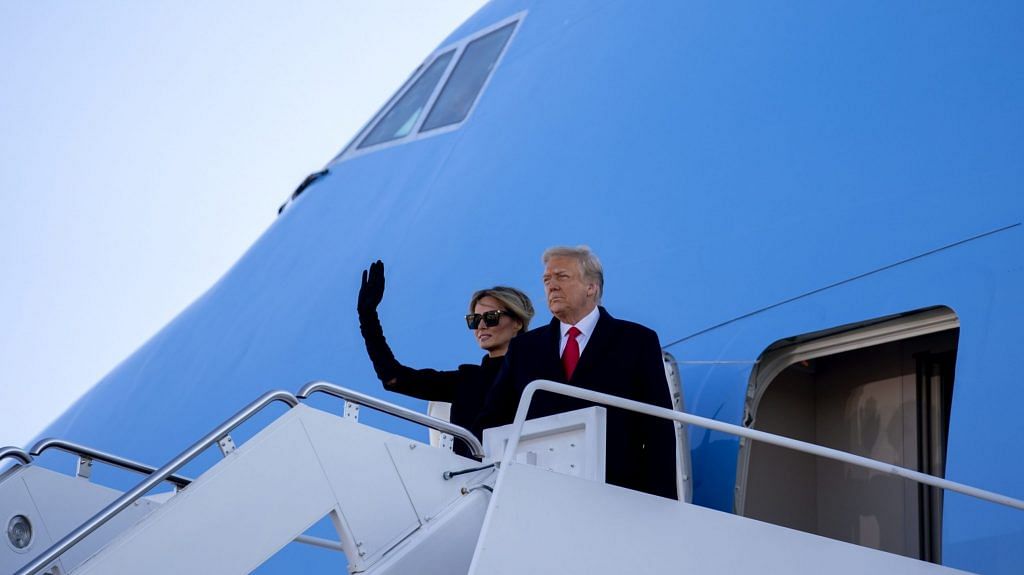 Former US President Donald Trump and Melania Trump board Air Force One during a farewell ceremony at Joint Base Andrews, Maryland, US, on Wednesday, Jan. 20, 2021. | Photographer: Stefani Reynolds | Bloomberg