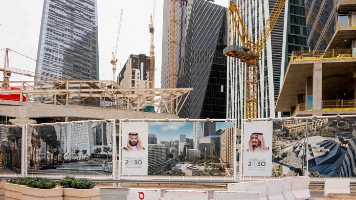 Portraits of Mohammed bin Salman and King Salman at a construction site in the King Abdullah Financial District in Riyadh. | Photographer: Tasneem Alsultan | Bloomberg