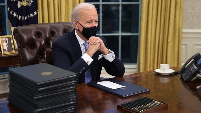 US President Joe Biden sits in the Oval Office after being sworn in on 20 January, 2021 | Bloomberg