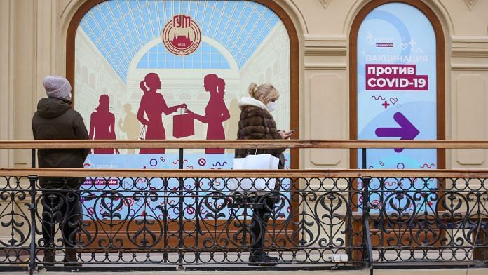 People queue outside a Covid-19 vaccination centre inside the GUM luxury department store in Moscow, Russia | Bloomberg