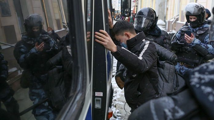 Riot police detain a supporter of Alexey Navalny, Russian opposition leader, during a demonstration in Moscow, Russia | Bloomberg