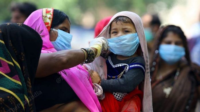 A mother adjusting her child's mask | Representational image | Suraj Singh Bisht | ThePrint